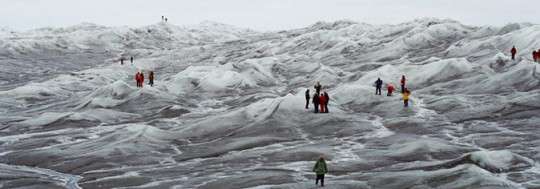 Tourist walking atop a glacier in Greenland. Photo: Greenland Tourism