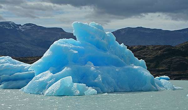 Some icebergs are blue, for the same reason water is blue. The chemical bond between oxygen and hydrogen in water absorbs light in the red end of the visible light spectrum. ©Candice Gaukel Andrews