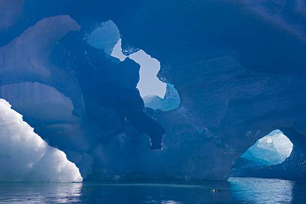 Inside an iceberg “cave,” you may discover shimmering turquoise ice crystals. ©Candice Gaukel Andrews