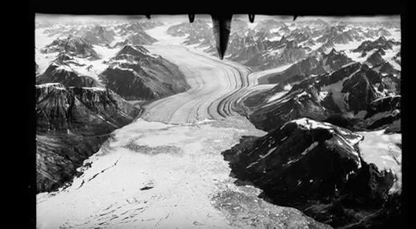 The 1930s photos were captured with a rotating camera flown in an open hydroplane, the tail of which you can see in the upper center. ©From the video “Glaciers Lost in Time” by Nature Video