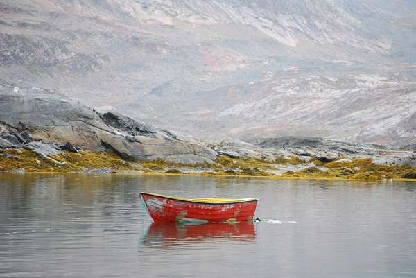 A cloudy day near Tinit made this boat’s weathered coat of cheery red paint pop.