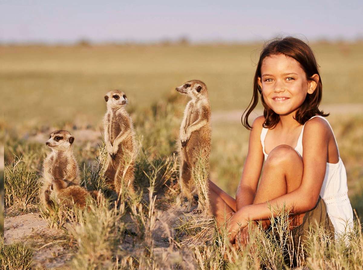 Girl with meerkats in Africa.