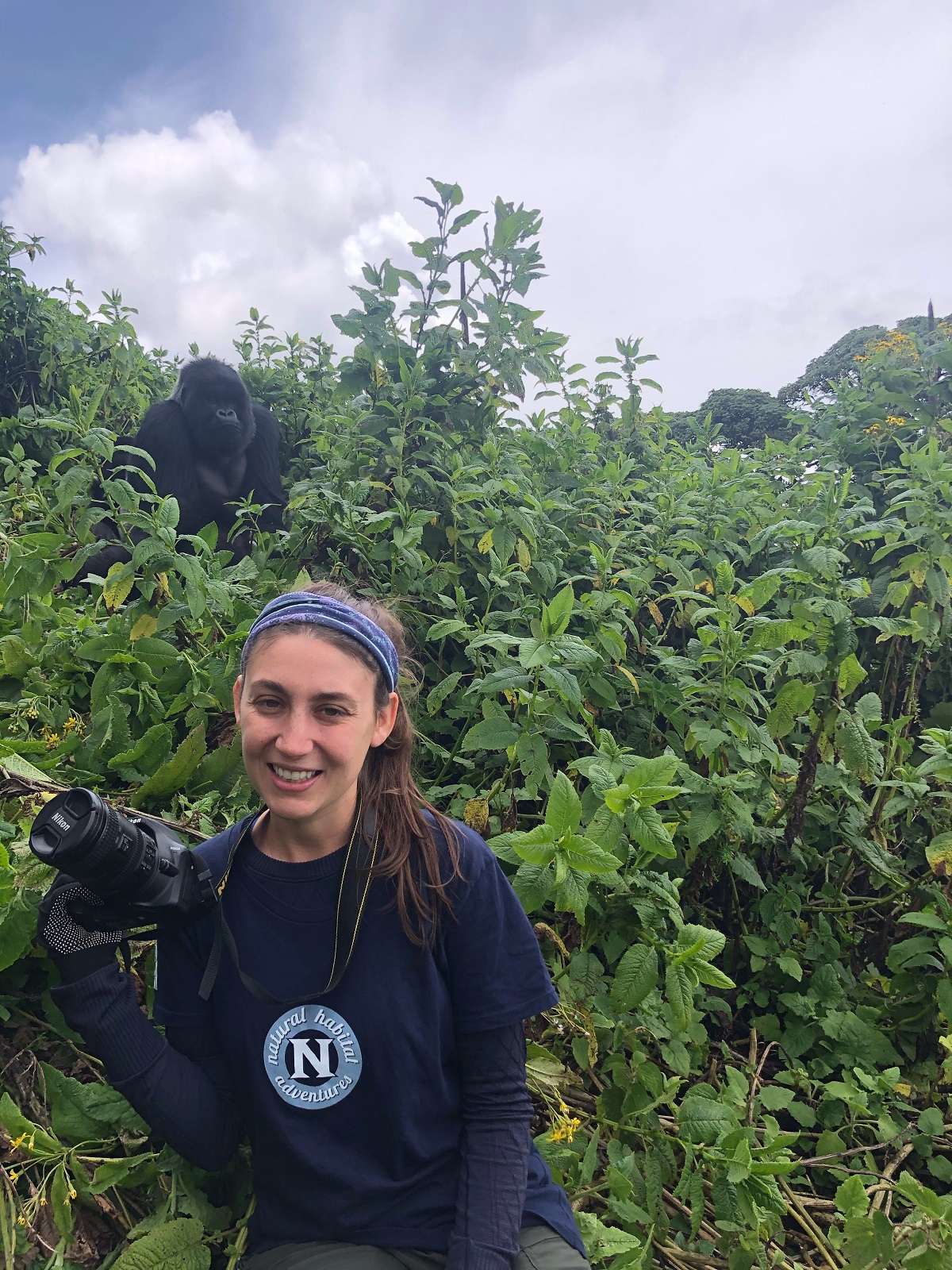 Girl with gorillas in Uganda on a Nat Hab safari. 