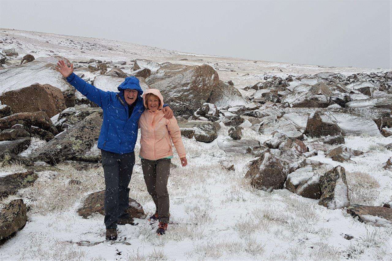 Nat Hab travelers pose in the snow in Yellowstone. 