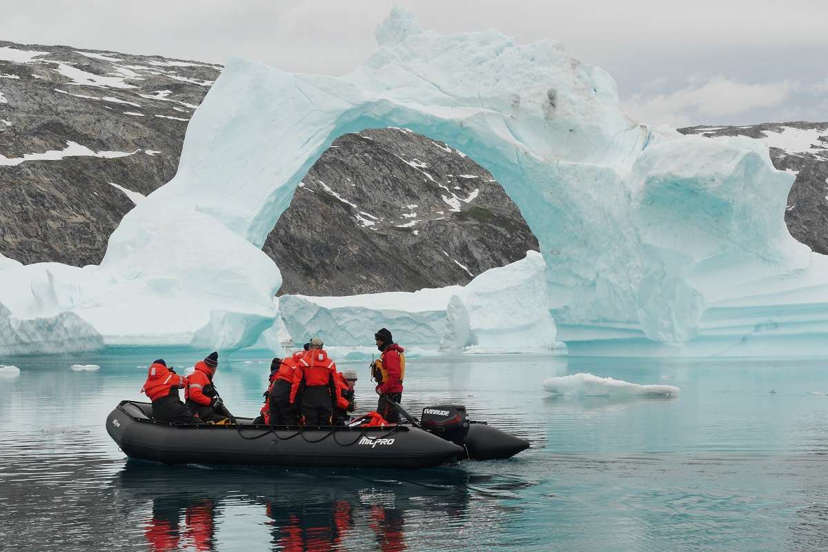 Nat Hab travelers on a Zodiac among icebergs in Greenland. 
