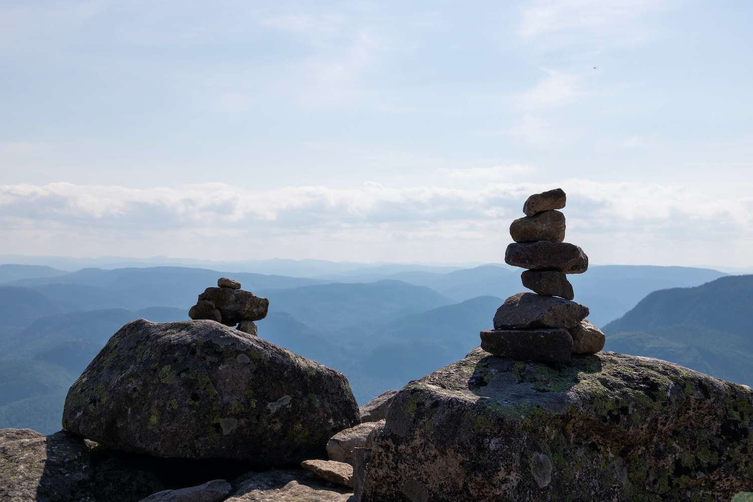 Two cairns (Inukshuk rocks) on top of a mountain in the Grands-Jardins National Park in the Charlevoix Region in Quebec, Canada.