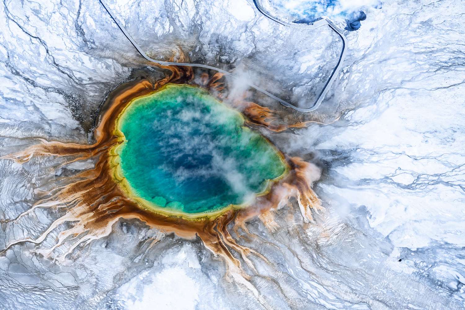 Aerial view of Grand prismatic spring in Yellowstone national park in Winter, Taken from a small plane, Wyoming, USA