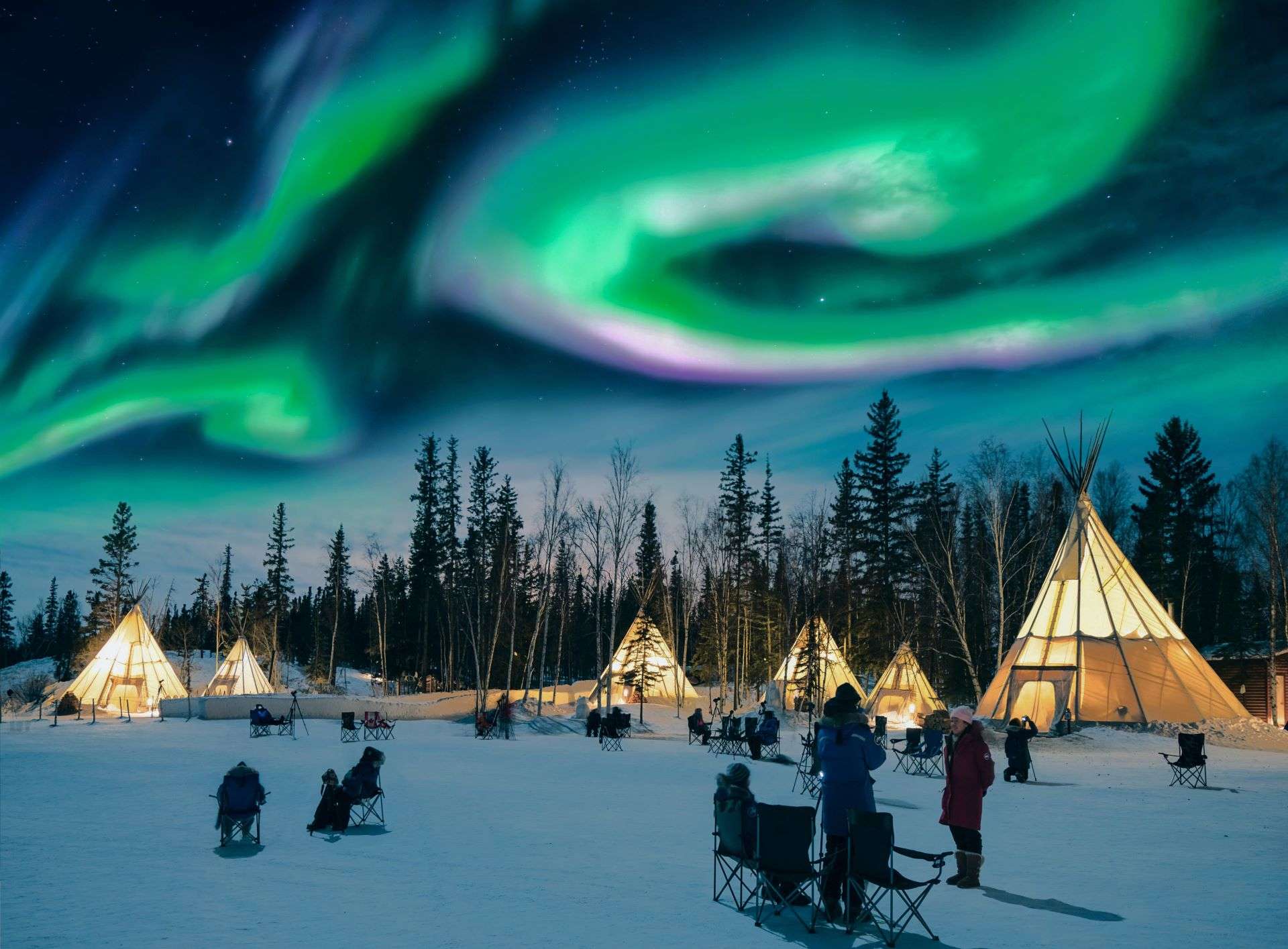 People camping outside in order to observe the Northern lights.