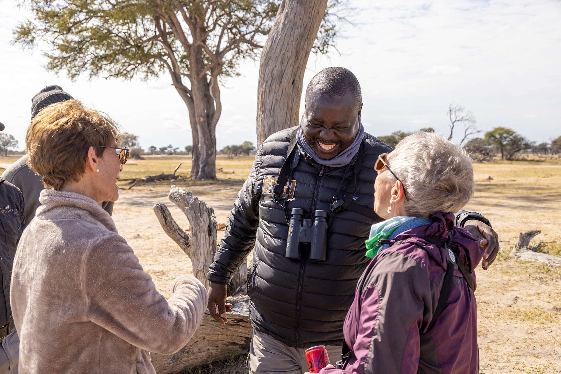 Nat Hab Expedition Leader naturalist wildlife guide laughing with guest travelers on safari in Zimbabwe Africa