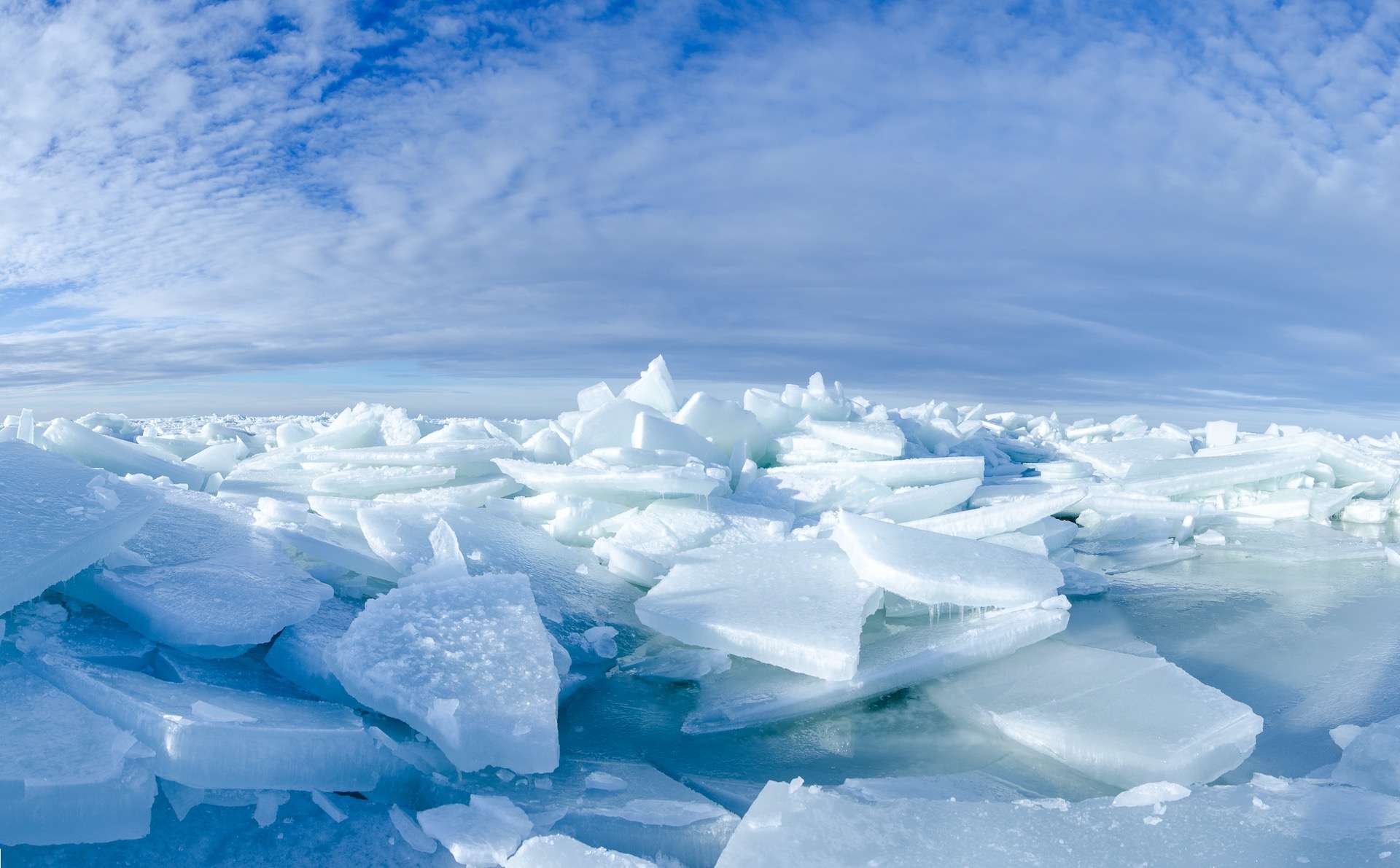 Baltic Sea on wintertime with broken ice cracks. Large pieces of floating ice driven into the seaside. Pack Ice builds up the icebergs. Panorama