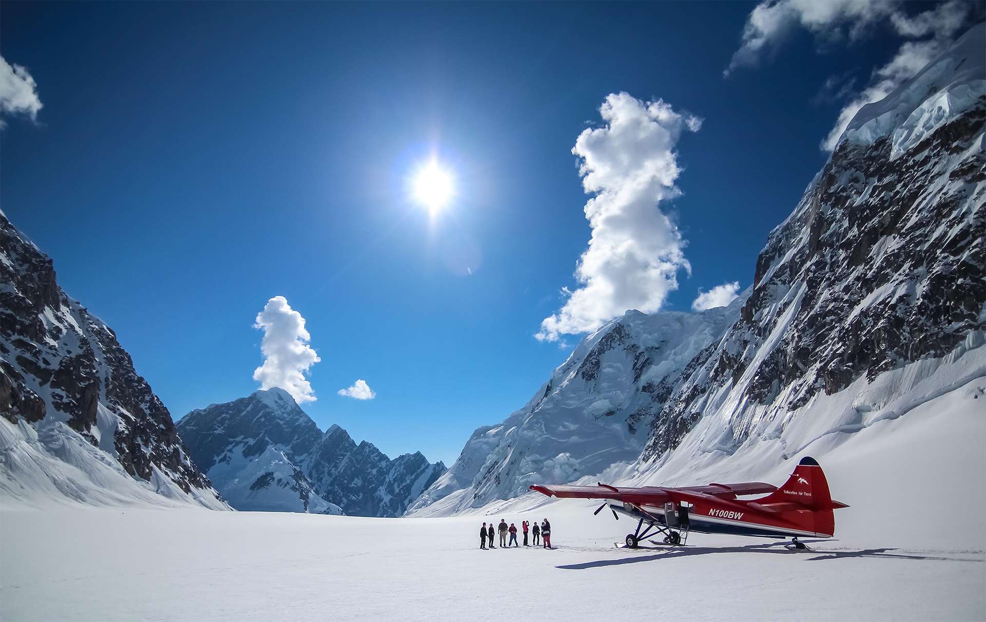 Talkeetna Air Glacial landing Denali flank mountain crisp snow blue skies airplane scenic flight
