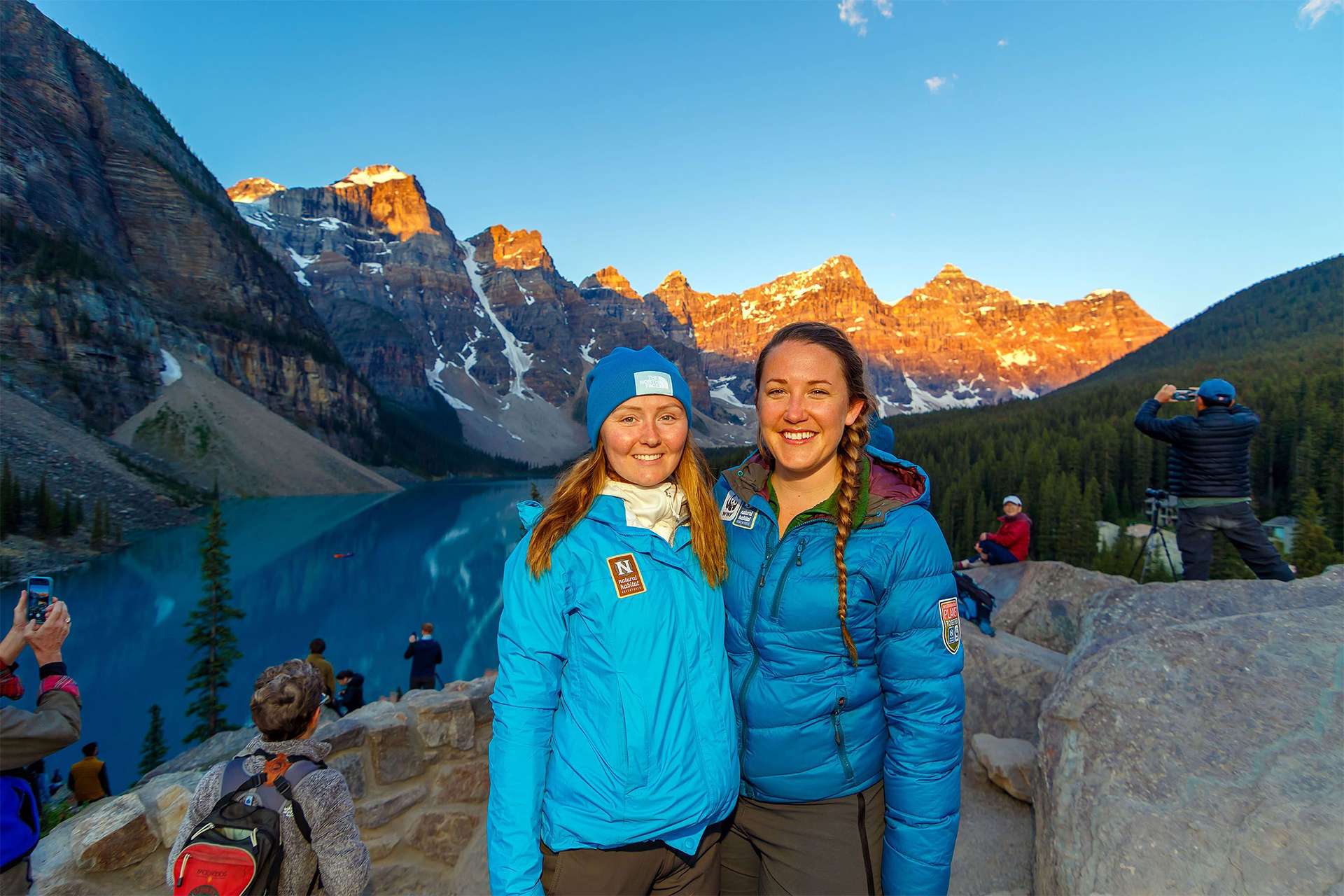 Nat Hab travelers pose in front of famous Moraine Lake in Banff National Park TeamJiX