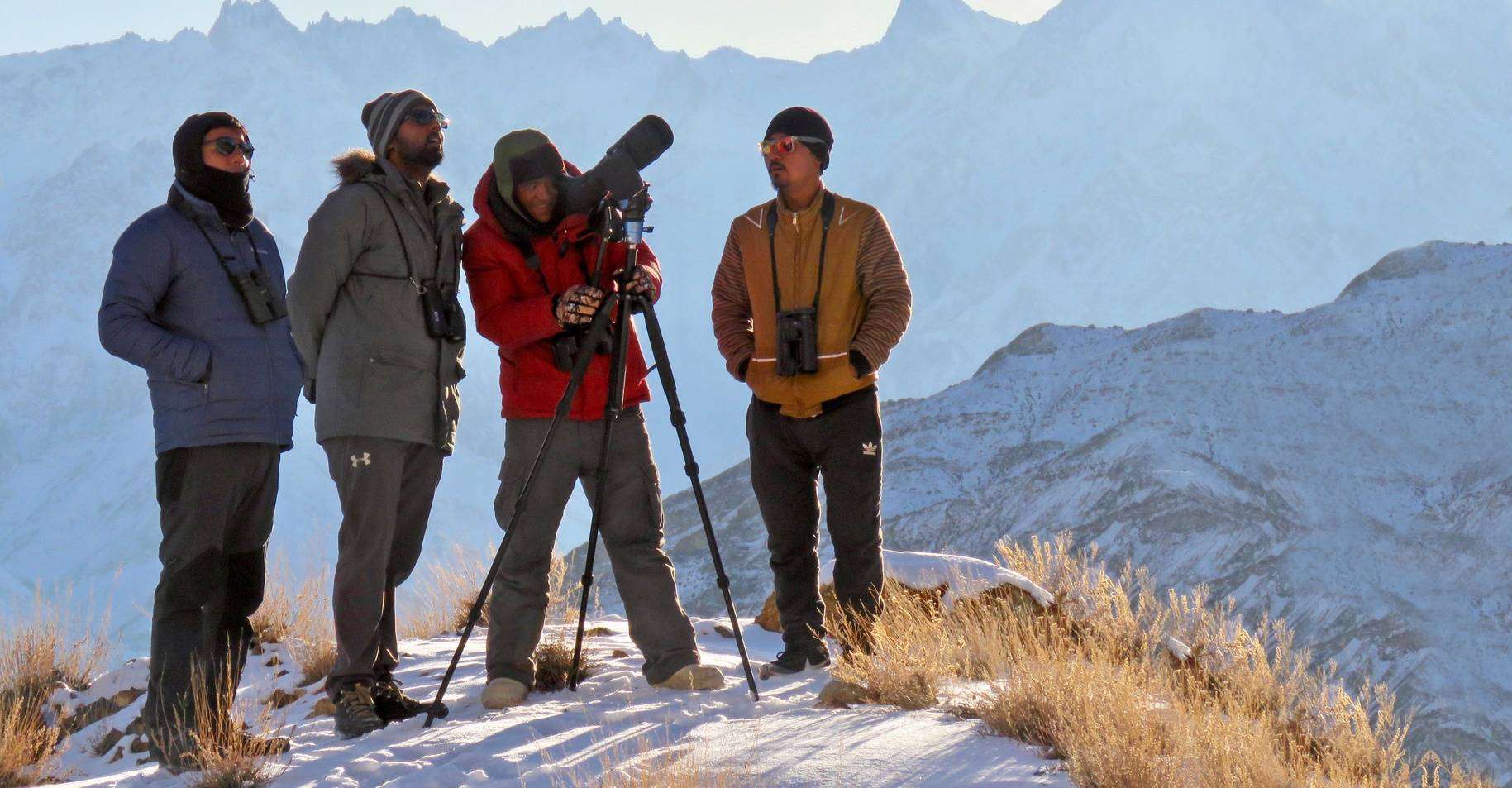 Photographers in the snow leopards habitat in the Himalayas