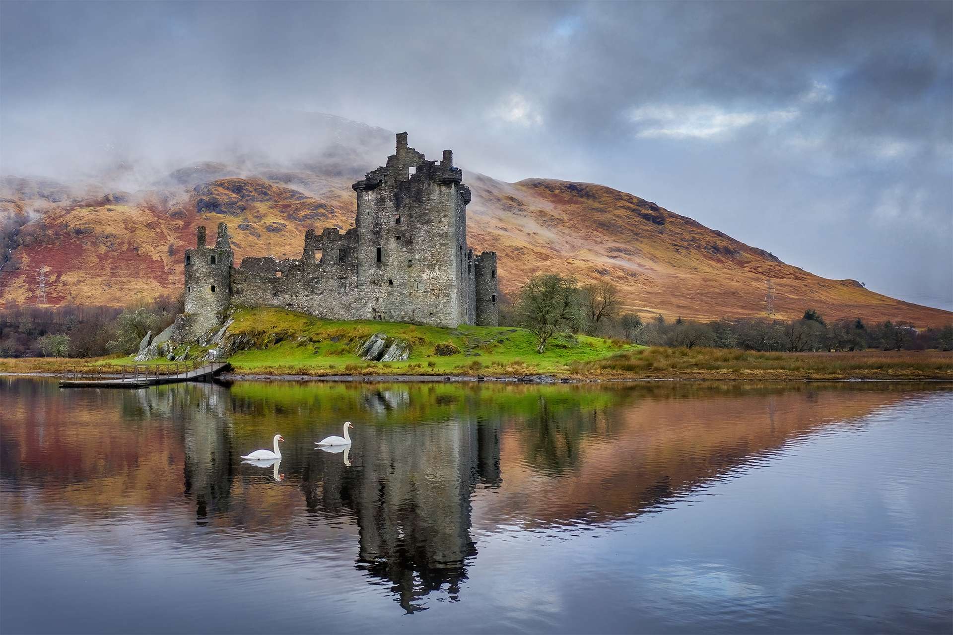 Kilchurn Castle on Loch Awe in the Scottish highlands near Glencoe and Oban. Historic castle in Scotland reflected in the loch with swans swimming past