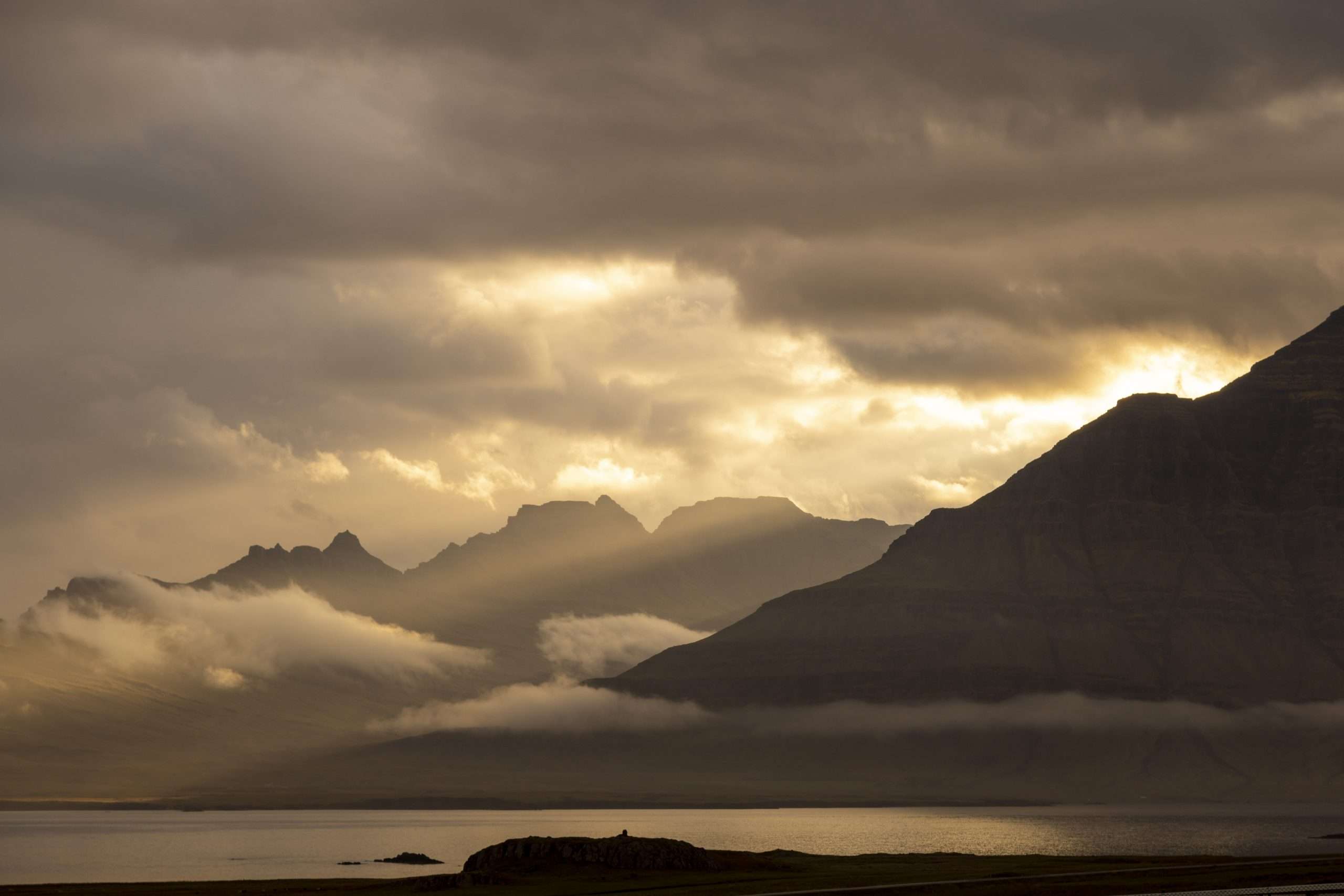 Dramatic landscape scenery in iceland sunlight piercing the clouds and sky