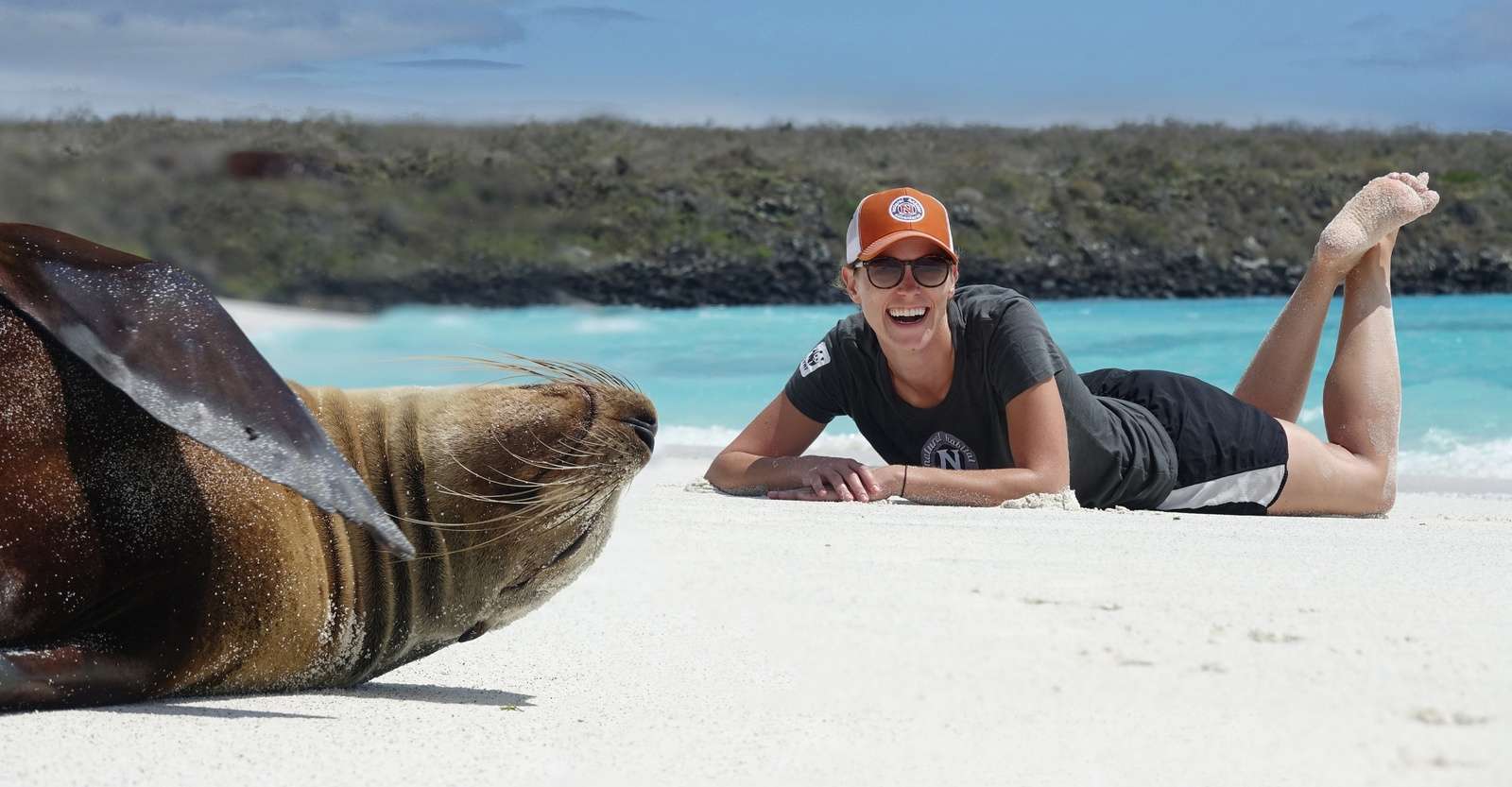 Nat Hab guest with Galapagos sea lion, San Cristobal Island, Galapagos, Ecuador.