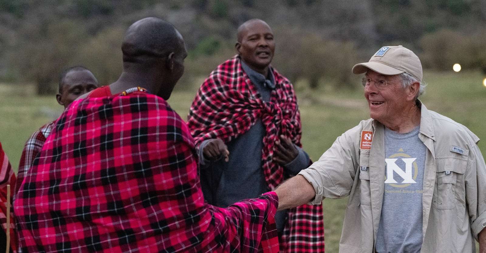 Maasai and guest at Nat Hab’s Migration Camp, Maasai Mara National Reserve, Kenya.