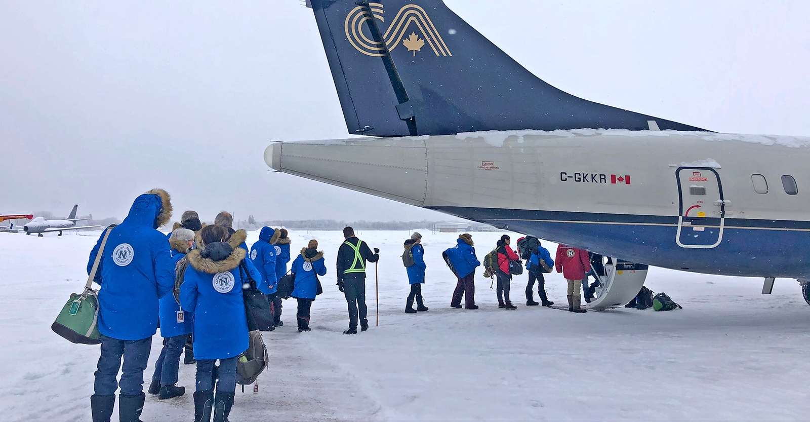 Nat Hab guests boarding a private charter plane, Churchill, Manitoba.