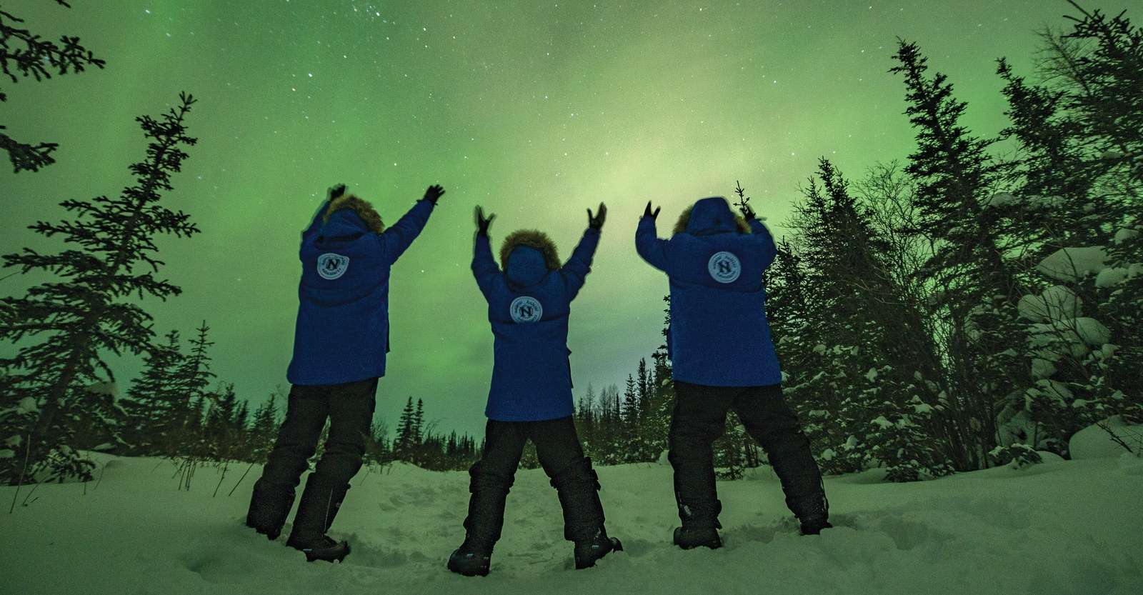 Nat Hab guests cheering the northern lights, Churchill, Manitoba.