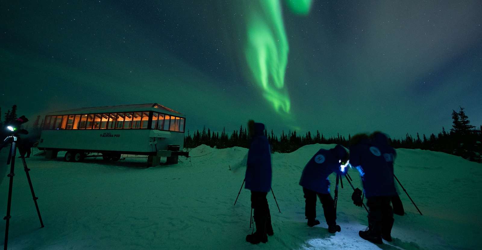 Travelers taking photos of northern lights outside of Nat Hab