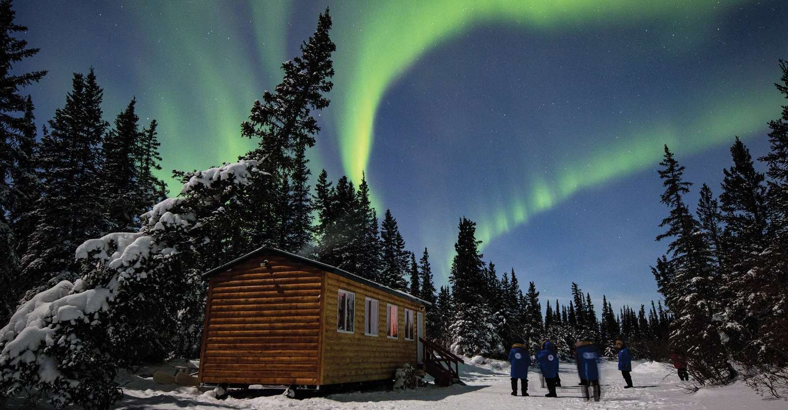 Northern lights above cabin in the boreal forest, Churchill, Manitoba.